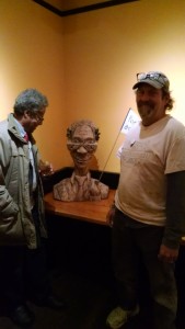 Sam Cornish admires an early version of his portrait by artist and poet, Stanley Stamatel.